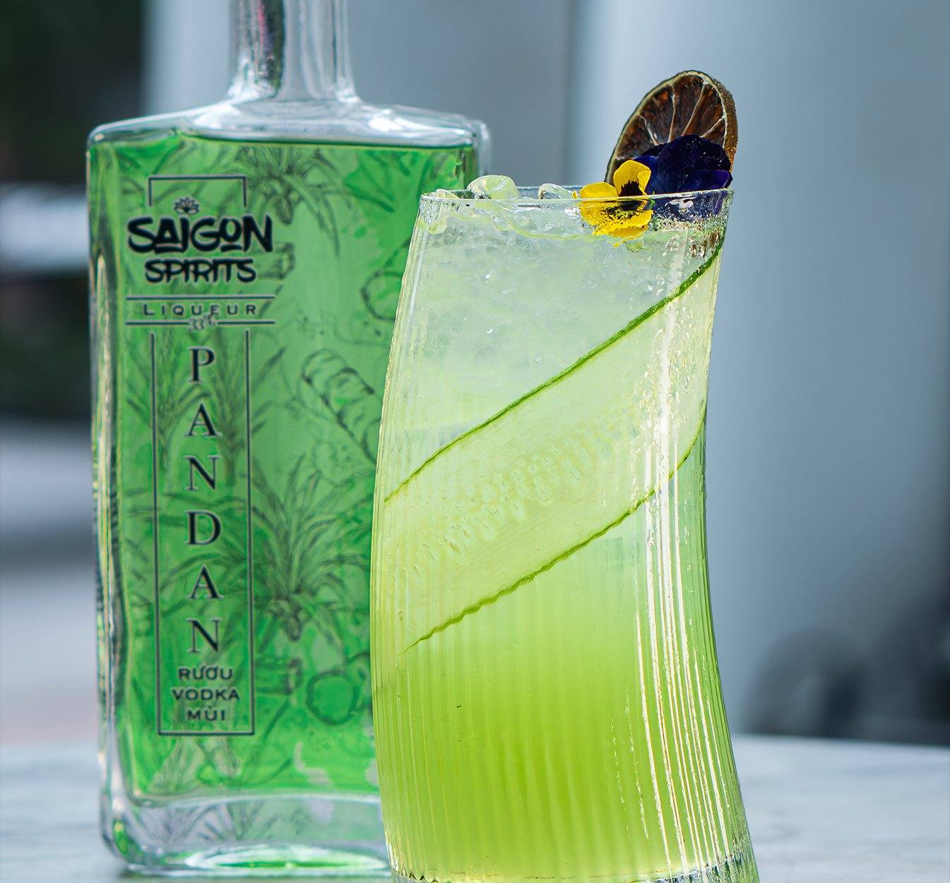 Miss Saigon cocktail recipe Pandan Liqueur Saigon Spirits green cucumber ribbon edible flower Vietnam Southeast Asian craft spirits